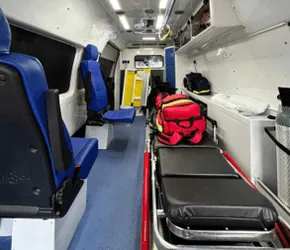 Crew seating alongside the main stretcher and response bags inside a Medlink ambulance