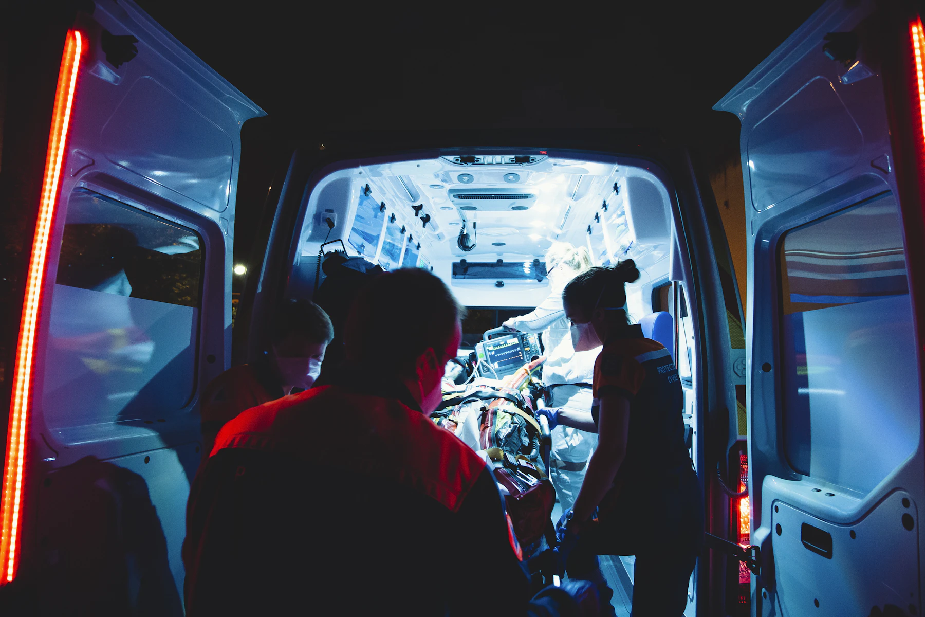 Medlink paramedics working inside an ambulance at night